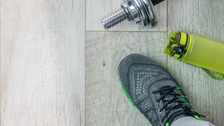 Fitness objects isolated on wooden background. Gray Sneakers, dumbbells and water bottle. Active, healthy lifestyle, sport, fitness, and objects concept. More of my photos and videos Adobe Stock:http://bit.ly/3RqlciK More of my photos and videos Shutterstock: https://www.shutterstock.com/g/ALEKSANDRBERDYUGIN My email: bermix999@gmail.com